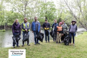 group of people cleaning a riverbank